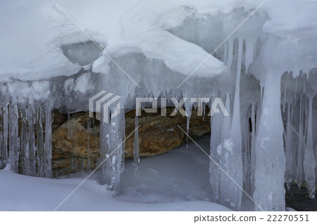 Huge icicles on a cliff. Huge icicles on a cliff. 22270551