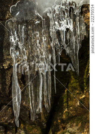 Huge icicles on a cliff. Huge icicles on a cliff. 22270554
