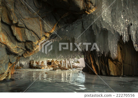 Multicolored stone grotto with icicles. Multicolored stone grotto with icicles. 22270556