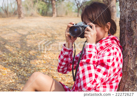 Tourist woman holding vintage old photo camera Tourist woman holding vintage old photo camera 22272627