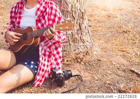 Beautiful asian women playing ukulele guitar Beautiful asian women playing ukulele guitar 22272628