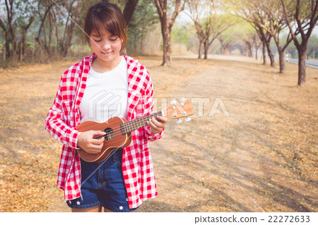 Beautiful asian women playing ukulele guitar  22272633