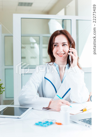 Woman doctor sitting at the table Woman doctor sitting at the table 22273489