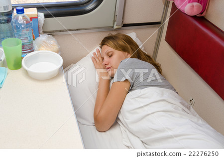 The girl on the train is fast asleep at a lower second-class place car coupe The girl on the train is fast asleep at a lower second-class place car coupe 22276250