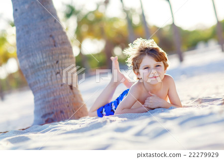 Little kid boy having fun on tropical beach 22279929