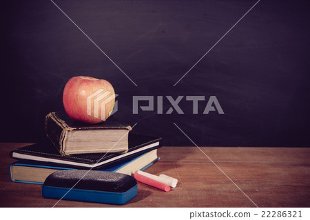 Apple, Books and Chalks with Blackboard Background 22286321