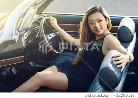 Attractive girl sitting in vintage car Attractive girl sitting in vintage car 22290182
