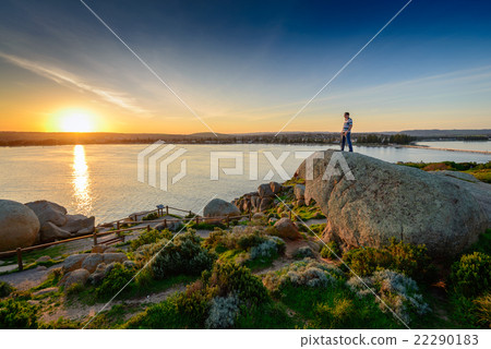 Man standing on the edge of the rock Man standing on the edge of the rock 22290183
