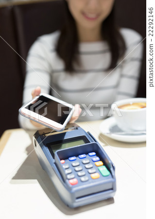woman pay by smart phone woman pay by smart phone 22292146
