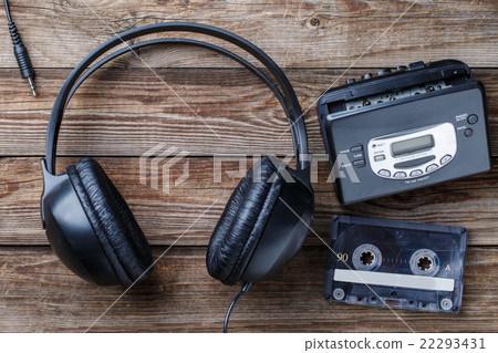 Headphones, player and retro compact cassette over Headphones, player and retro compact cassette over 22293431