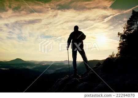 Silhouette of alone hiker with poles in hand. Silhouette of alone hiker with poles in hand. 22294070