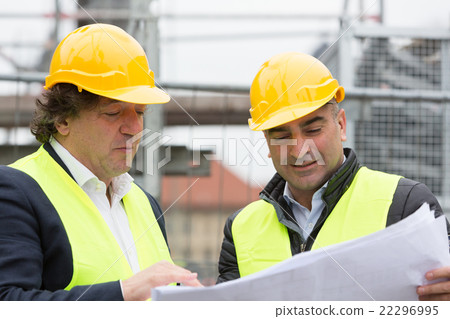Construction site managers explaining blueprints Construction site managers explaining blueprints 22296995