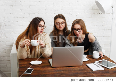 Three young women friends with laptop. Three young women friends with laptop. 22297673