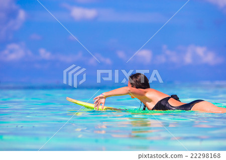 Beautiful fitness surfer woman surfing during Beautiful fitness surfer woman surfing during 22298168