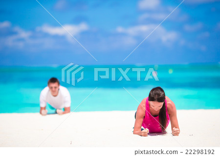 Young fitness couple doing push-ups during outdoor Young fitness couple doing push-ups during outdoor 22298192