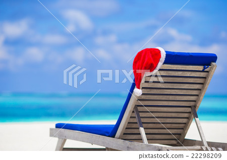 Sun chair lounge with red Santa Hat on tropical Sun chair lounge with red Santa Hat on tropical 22298209