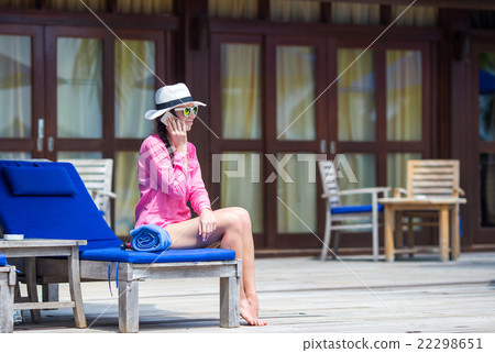 Young beautiful woman talking by phone at tropical 22298651