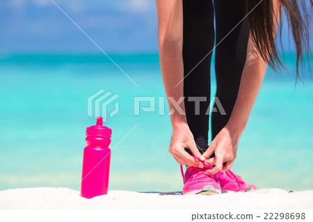 Closeup fitness woman tying running shoe laces 22298698