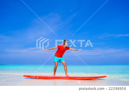 Happy young man practicing surfing position on Happy young man practicing surfing position on 22298958