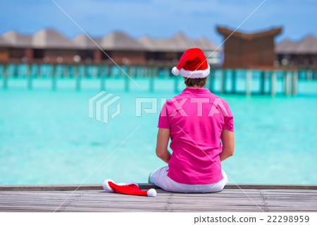 Young man in santa hat during beach vacation on Young man in santa hat during beach vacation on 22298959