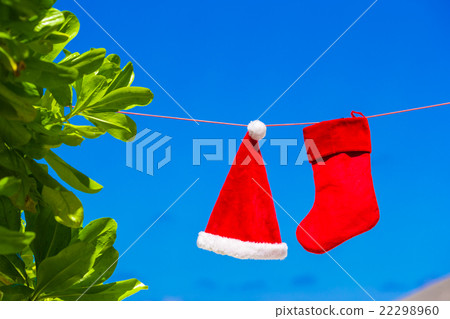 Red Santa hat and Christmas stocking hanging on Red Santa hat and Christmas stocking hanging on 22298960