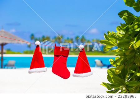 Red Santa hats and Christmas stocking hanging on Red Santa hats and Christmas stocking hanging on 22298963