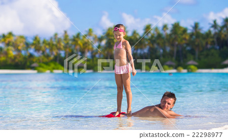 Little girl at beach practicing surfing position Little girl at beach practicing surfing position 22298977