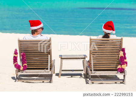 Back view of young couple in Santa hats relaxing Back view of young couple in Santa hats relaxing 22299153