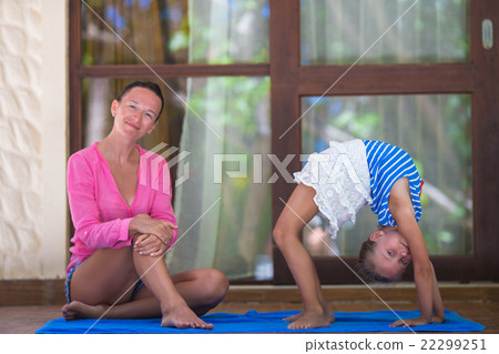 Young woman and little girl engaged in fitness Young woman and little girl engaged in fitness 22299251
