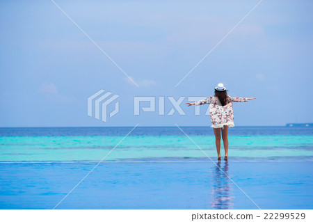 Beautiful young girl relaxing in outdoor swimming 22299529