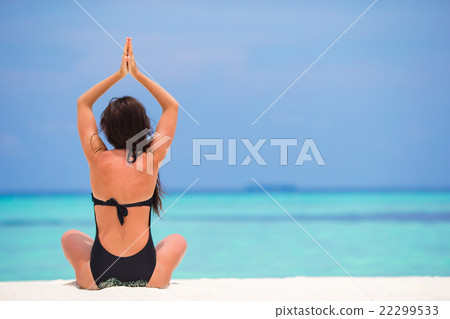 Young woman sitting in yoga position during Young woman sitting in yoga position during 22299533