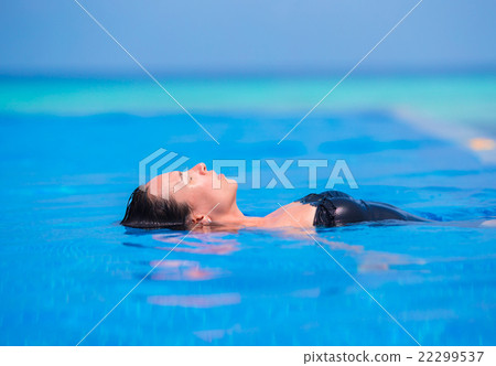 Young woman enjoying water and sun in outdoor 22299537