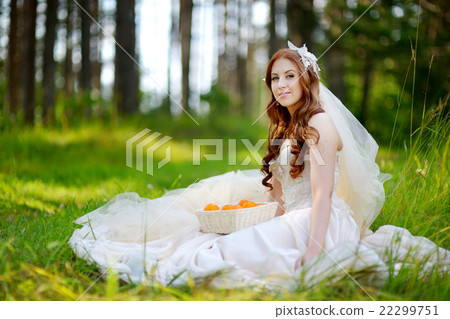 Young bride sitting on a grass Young bride sitting on a grass 22299751