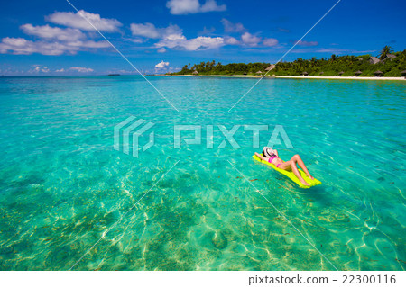 Woman relaxing on inflatable air mattress at Woman relaxing on inflatable air mattress at 22300116