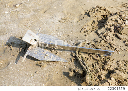 Stainless steel anchor in the sand on the coast Stainless steel anchor in the sand on the coast 22301859