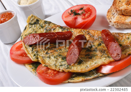 Omelet with spinach, tomatoes and sausage close-up Omelet with spinach, tomatoes and sausage close-up 22302485