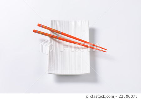 Orange chopsticks on empty sushi plate 22306073