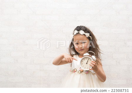 Girl pointing at the alarm clock Girl pointing at the alarm clock 22308731