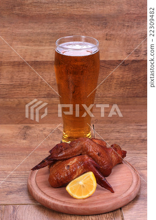 glass of beer with a snack of chicken grill wings glass of beer with a snack of chicken grill wings 22309482