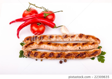 fried pork sausages on a barbecue on a wooden plat 22309635