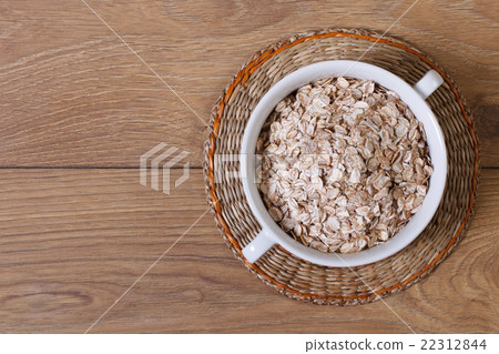 dry oat flakes on a plate top view dry oat flakes on a plate top view 22312844