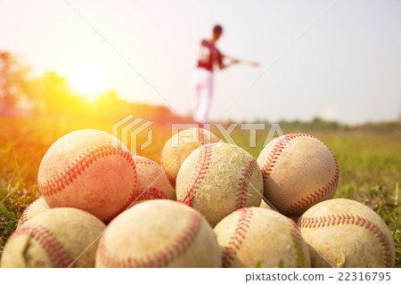 Baseball players practice wave a bat in a field 22316795