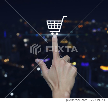 Hand pressing shopping cart icon over blur city Hand pressing shopping cart icon over blur city 22319141