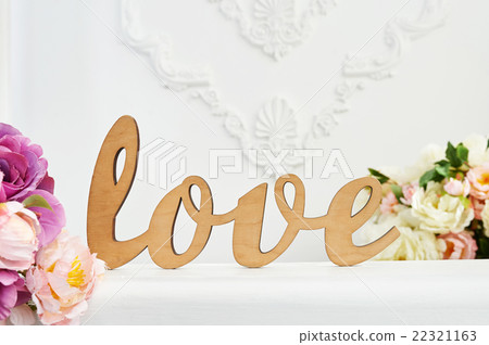 wooden word Love against white wall in the studio 22321163