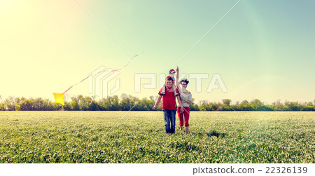 Family running with a kite. 22326139