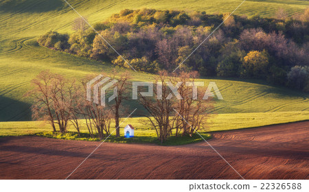 Spring landscape with chapel  green fields. Sunset 22326588