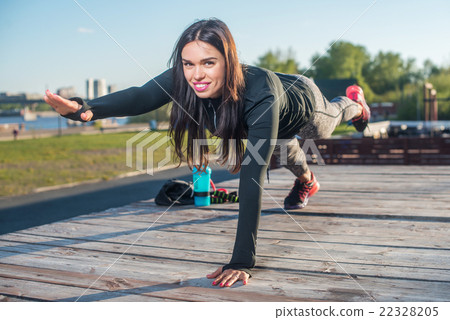 Fit woman doing raised leg plank yoga pilates Fit woman doing raised leg plank yoga pilates 22328205