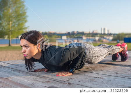 Sporty young woman doing plank exercise working on Sporty young woman doing plank exercise working on 22328206