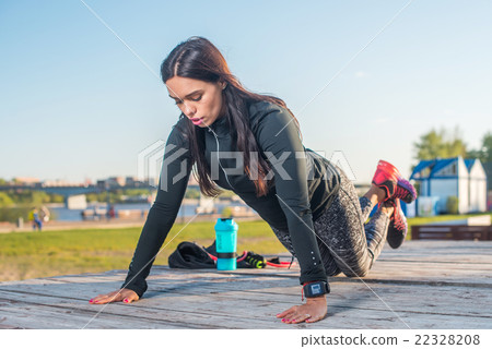 Fitness woman doing knee push-ups or press ups Fitness woman doing knee push-ups or press ups 22328208