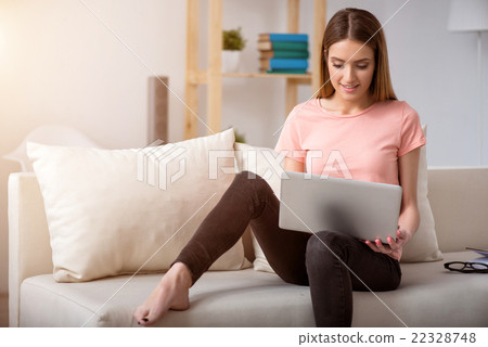 Pleasant woman resting on the couch  22328748